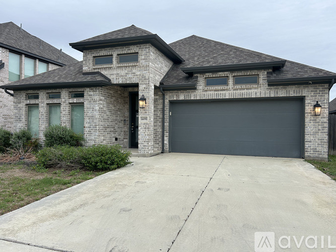 A house with a garage and a driveway in front.