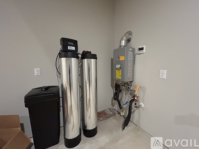 A water filtration system is installed next to a wall socket.