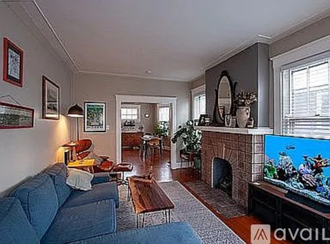 A living room with a blue couch and a television.