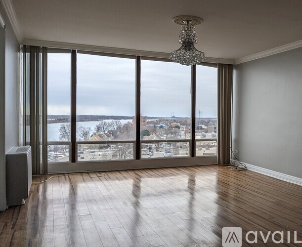 A room with a large window overlooking a snowy landscape.