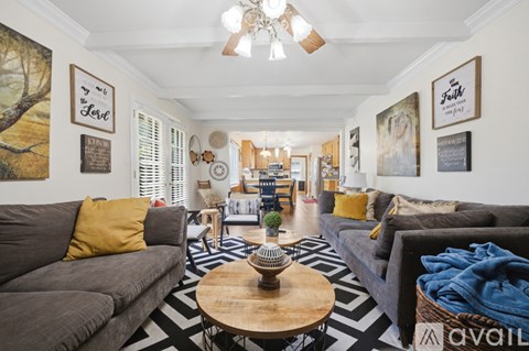 A living room with a grey couch and a wooden coffee table.