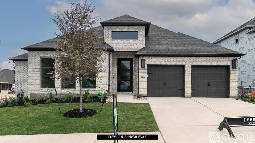 A house with a grey roof and a tree in front of it.