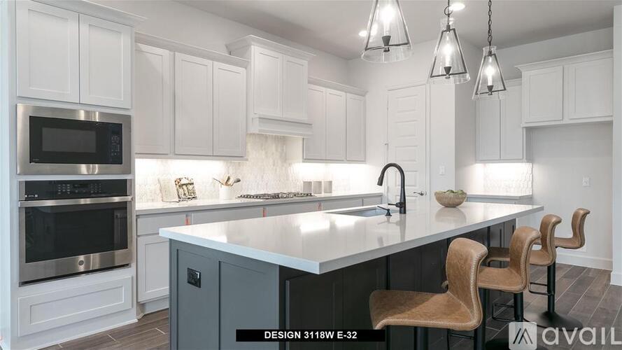 A kitchen with white cabinets and a black microwave.