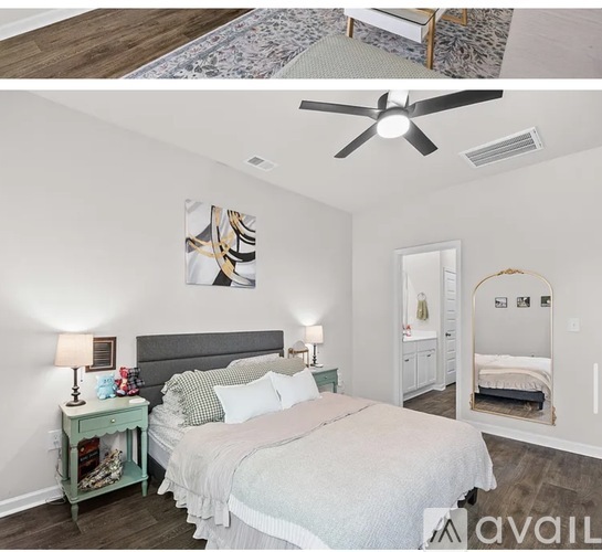 A bedroom with a large bed and a ceiling fan.