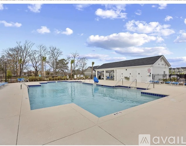 A large outdoor swimming pool with a building in the background.