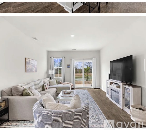 A living room with a grey sofa and a television.