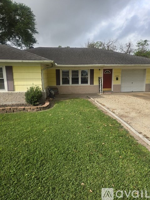 A house with a red door and a white garage door.