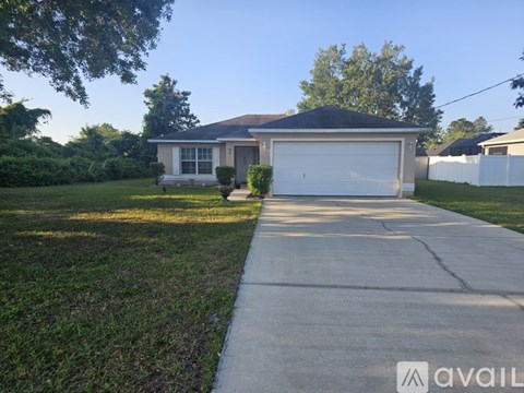 A house with a garage and a driveway in front.