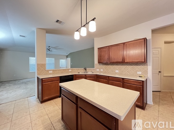 A kitchen with brown cabinets and a white countertop.
