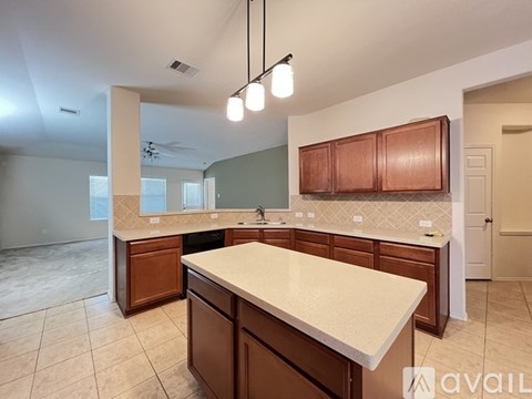 A kitchen with brown cabinets and a white countertop.