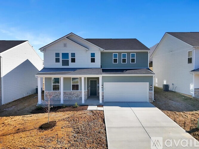 A house with a garage is for sale.