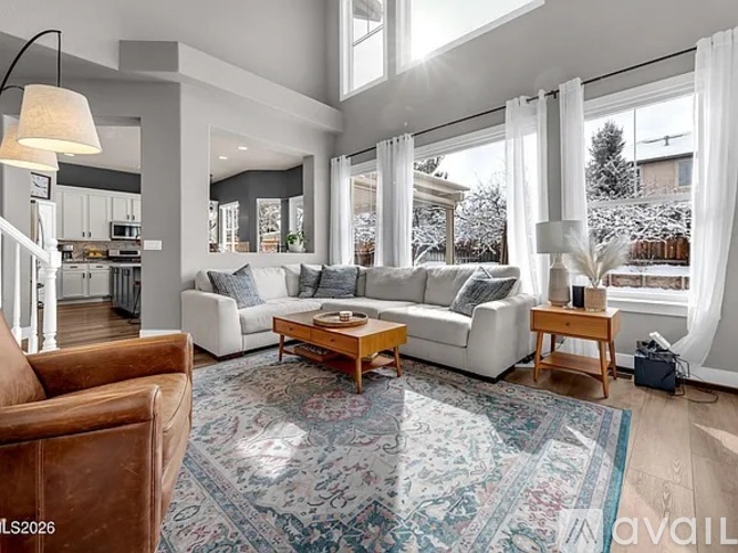 A living room with a brown leather chair and a white sofa with a wooden coffee table in the middle.