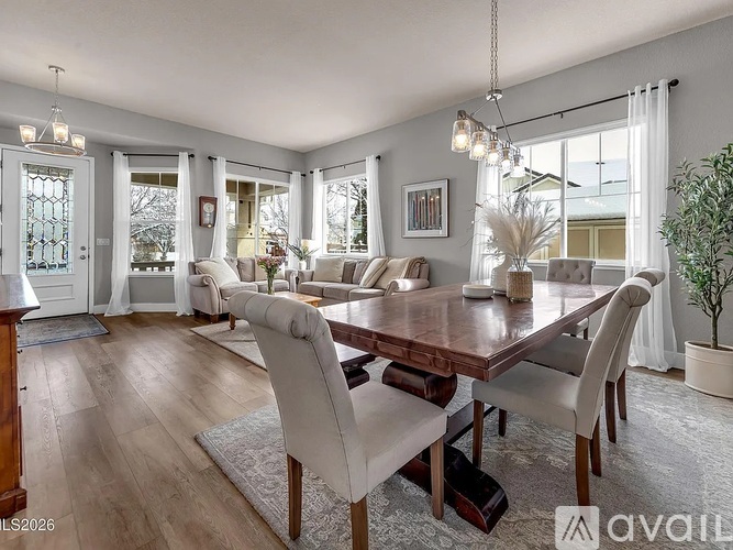 A dining room with a wooden table and chairs.