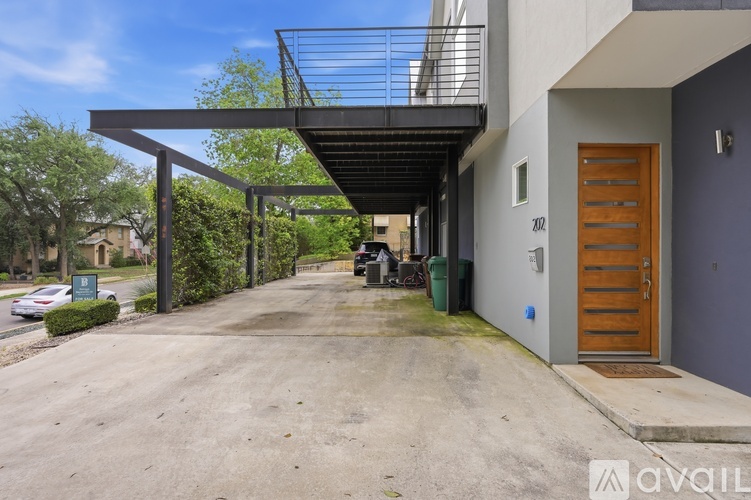 A modern house with a balcony and a wooden door.