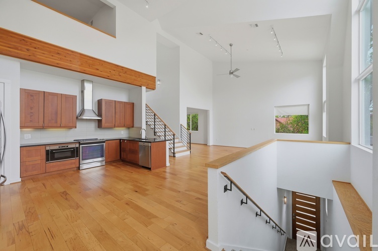 A spacious kitchen with wooden cabinets and a stainless steel oven.