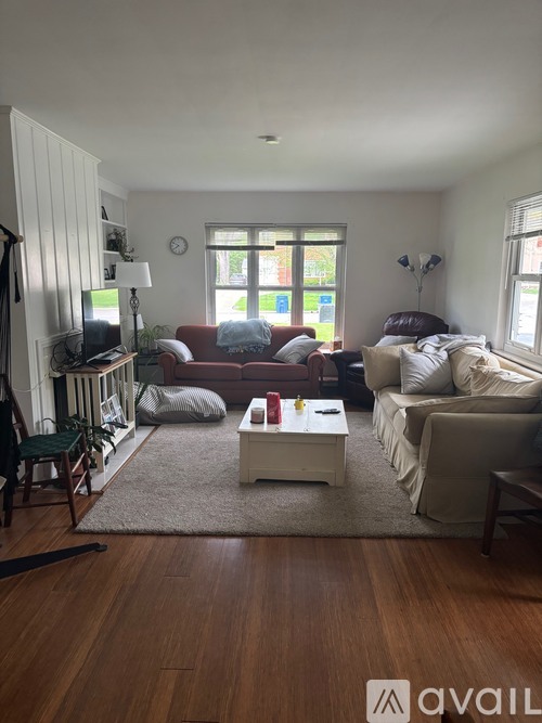 A living room with a couch, chair, and coffee table.
