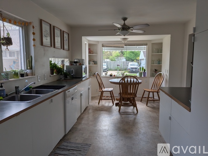 A kitchen with a table and chairs in the middle of it.