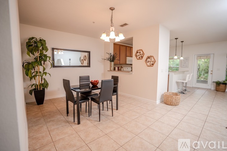 A dining room with a table set for four.
