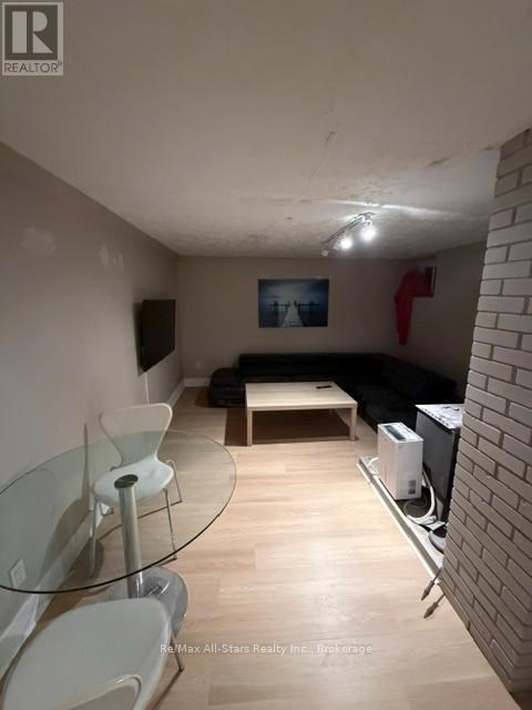 A living room with a glass table and chairs.
