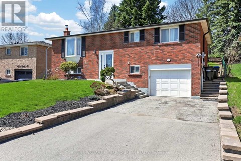 A red brick house with a white garage door.