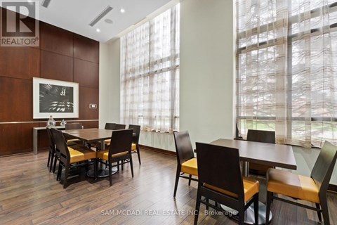 A dining room with a wooden table and chairs.