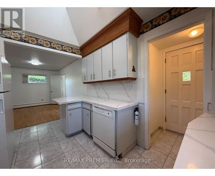 A kitchen with white cabinets and a wooden counter top.