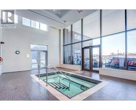 A large, empty room with a glass wall and a pool table.