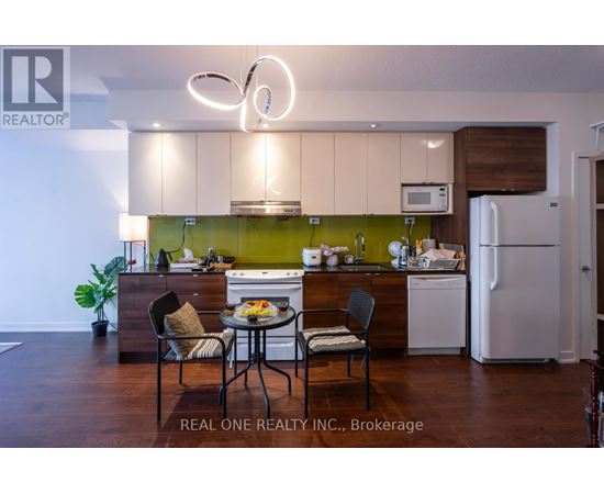 A modern kitchen with a dining table set for two.