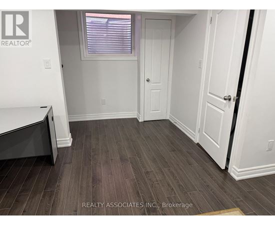 A room with a wooden floor and white walls.