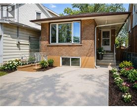 A house with a brown brick exterior and a white garage door.