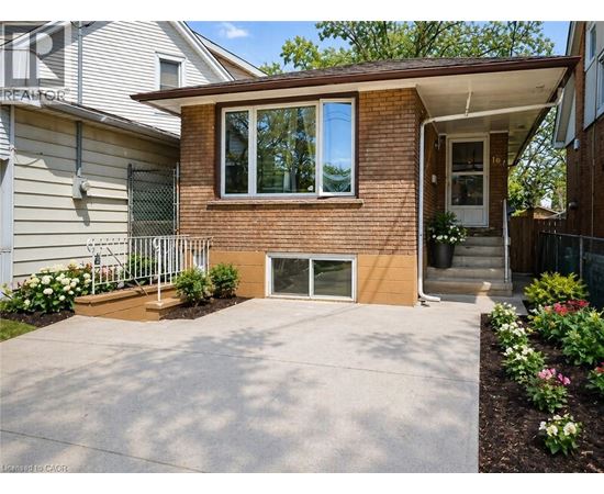 A house with a brown brick exterior and a white garage door.
