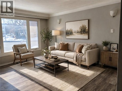 A living room with a couch, chair, and a painting on the wall.