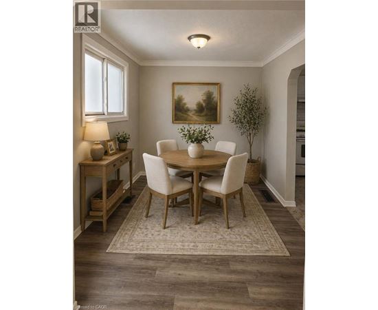 A dining room with a wooden table and chairs.
