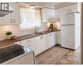 A kitchen with white cabinets and a tiled backsplash.