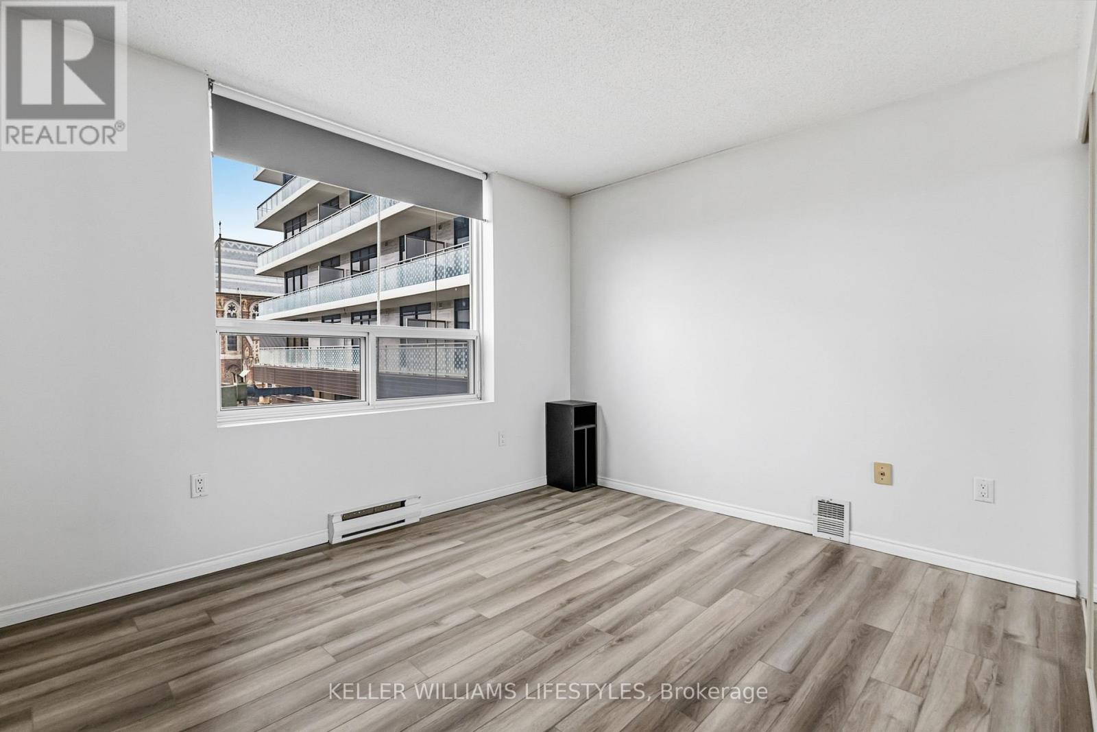 A spacious room with a view of a balcony and a balcony railing.