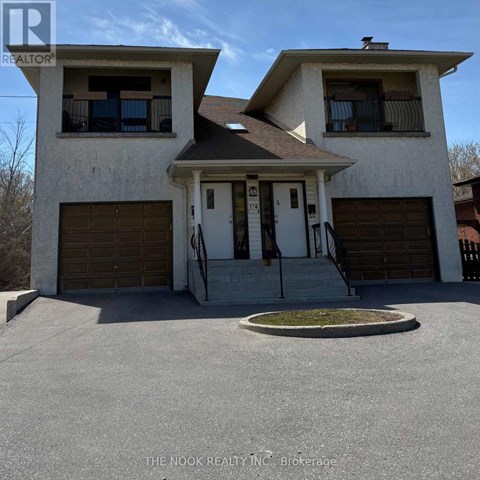 A two-story house with a garage is for sale.