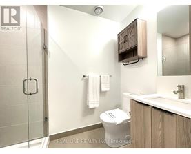 A white toilet sits next to a sink in a bathroom.