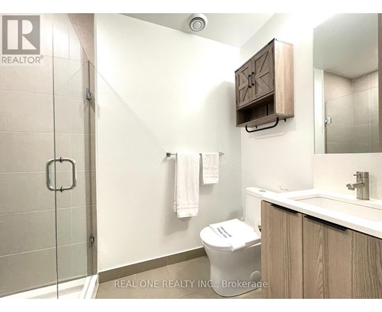 A white toilet sits next to a sink in a bathroom.