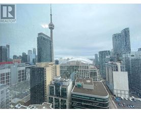 A cityscape with the CN Tower in the background.