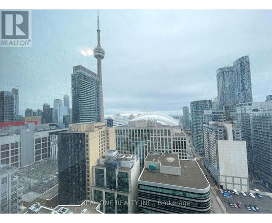 A cityscape with the CN Tower in the background.