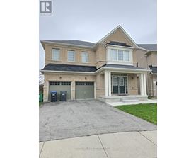 A two-story house with a garage and a driveway.