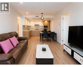 A living room with a brown leather couch and a white coffee table.