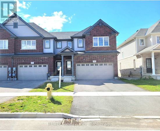 A house with a brick facade and a white garage door is for sale.