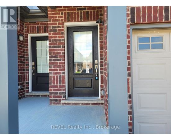 A house with a black door and a white garage door.