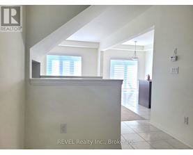 A white interior of a house with a window and a door.