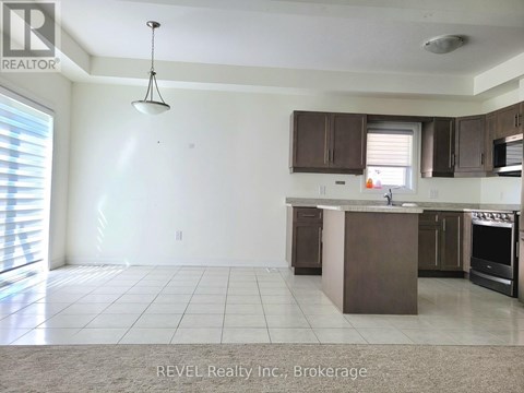A kitchen with a brown island and brown cabinets.
