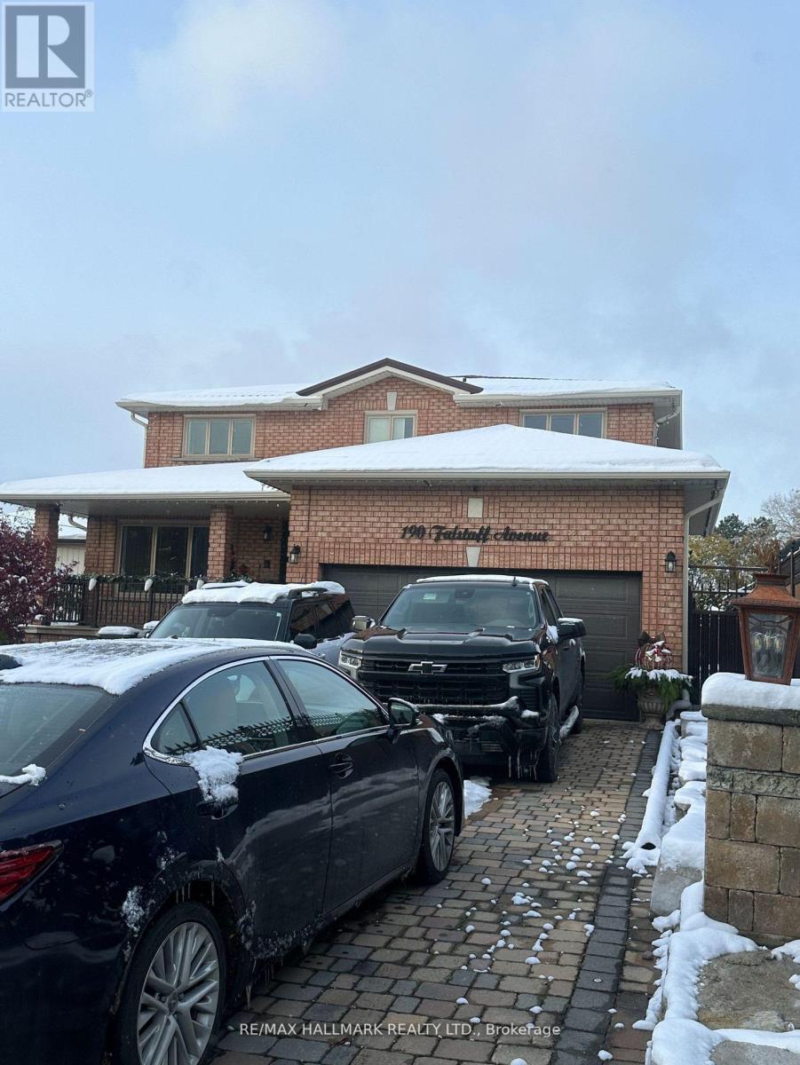 A car is parked in front of a house with a snow-covered roof.
