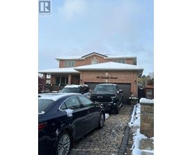 A car is parked in front of a house with a snow-covered roof.