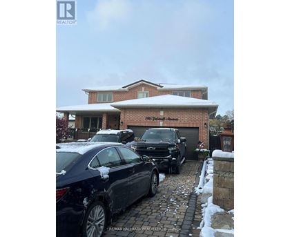 A car is parked in front of a house with a snow-covered roof.