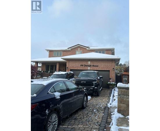 A car is parked in front of a house with a snow-covered roof.
